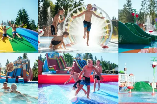 Dzieci bawią się w wodnym parku rozrywki, ślizgając się po tęczowej zjeżdżalni i biegając przez fontanny. Ten aquapark nad morzem to idealne miejsce na letnie szaleństwo.