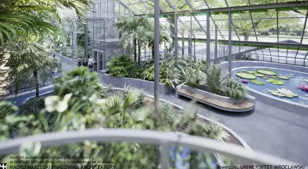Wrocław, palmiarnia w ogrodzie botanicznym: bujna roślinność, wodospad, staw z liliami wodnymi i ławka.