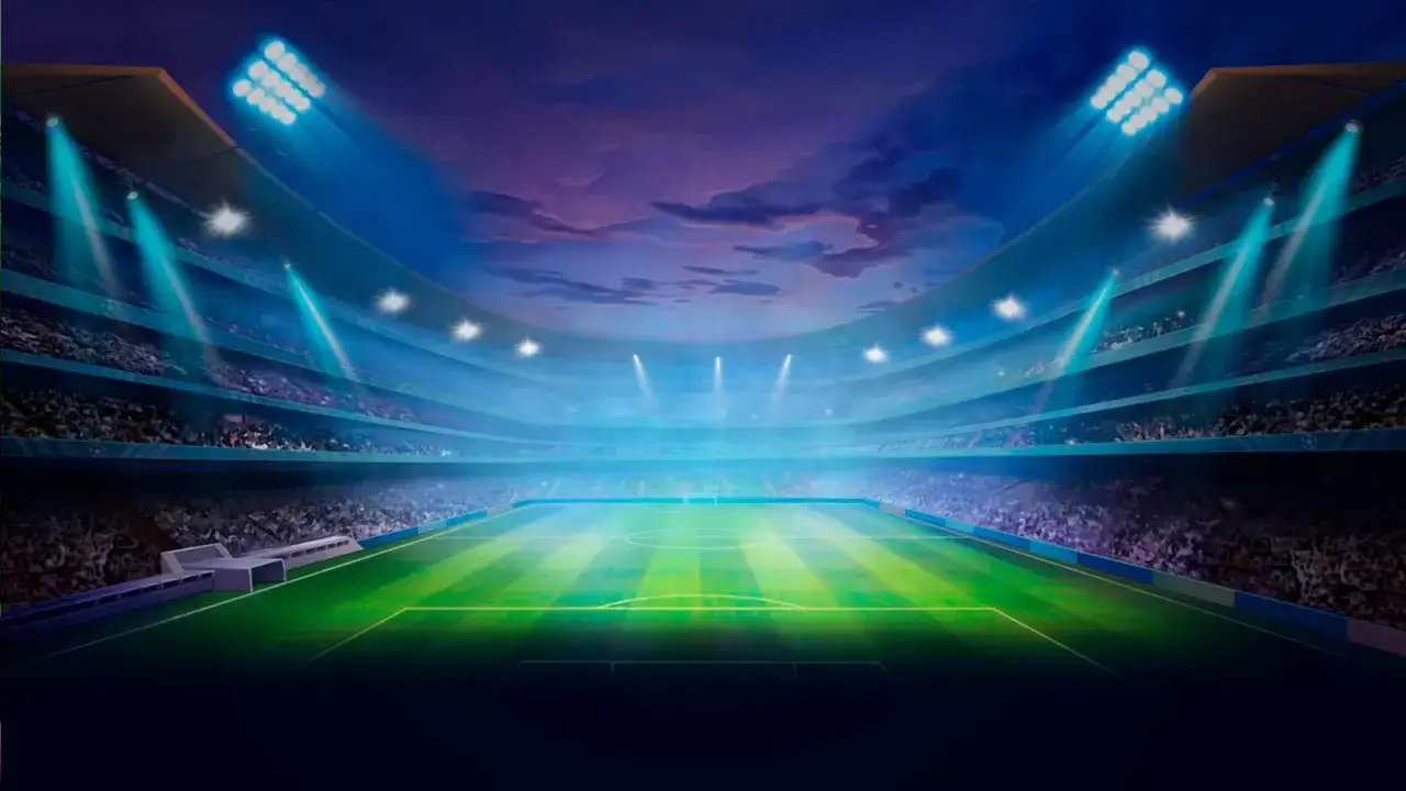 Piłkarski stadion nocą, oświetlony jaskrawymi reflektorami. Widok na murawę i trybuny pełne widzów. Idealne miejsce na emocjonujący Penalty Shoot Out — zasady, demo i RTP.